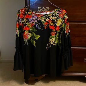 Black top with orange flowers around neckline.